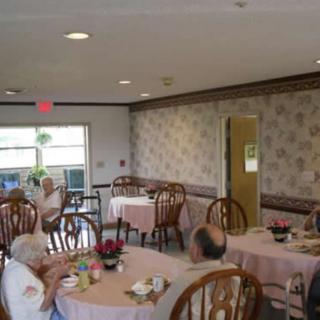A cozy dining room with elderly patrons seated at tables.