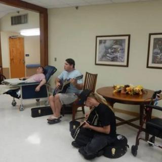 Musicians performing at a nursing home for residents.