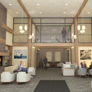 A modern office lobby with a reception desk, waiting area, and stylish decor.