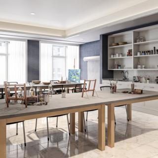 A spacious and modern dining area featuring a large wooden table and stylish chairs, illuminated by natural light.