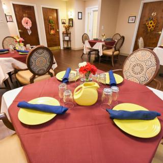A neatly set dining table in a cozy restaurant interior.