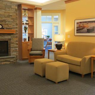 A cozy living room with a fireplace, sofa, and modern decor elements.