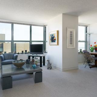 A modern living room with large windows, contemporary furniture, and ample natural light.