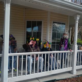 A cheerful group enjoying a sunny day on the porch.