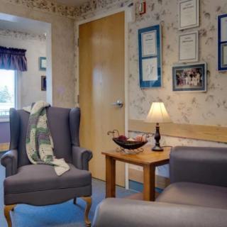 Cozy waiting room with armchairs, a sofa, and decorative elements.