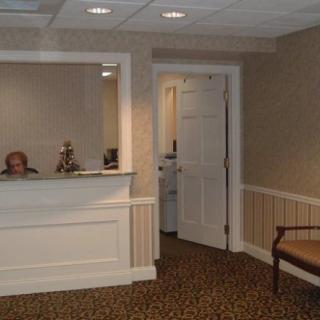 A quiet office reception area with a desk and seating.