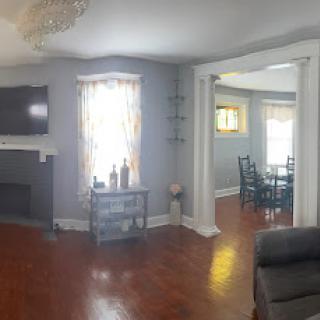 A cozy and modern living room with a warm atmosphere, featuring stylish furniture and a seamless transition to the dining area.