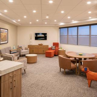 A modern meeting room with comfortable seating and conference table arrangements.