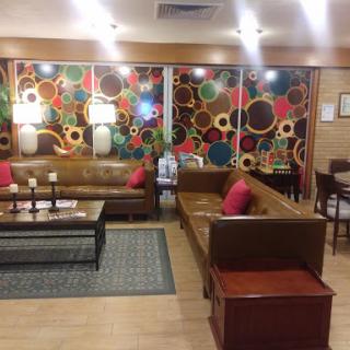 A cozy living room with stylish sofas and vibrant wall decorations.