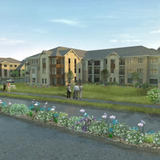A picturesque view of a modern residential complex surrounded by lush greenery.