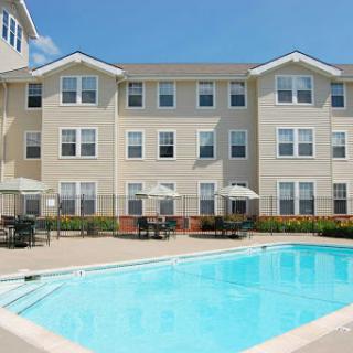 A sunny day by the apartment pool, perfect for relaxation and leisure.