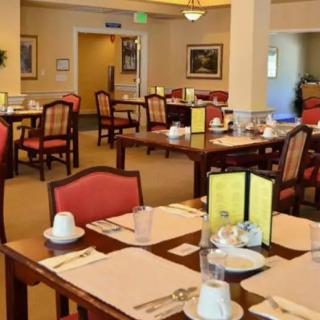 A neatly arranged dining area with tables set for a meal, featuring menus and comfortable seating.