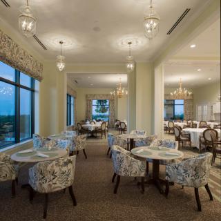 An elegant dining area with chandeliers and large windows providing a scenic view.