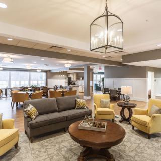 A spacious and well-lit living area with modern furniture and a cozy atmosphere.