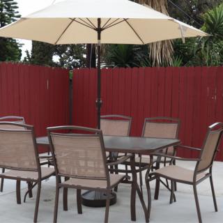Outdoor patio set with a table, chairs, and an umbrella.