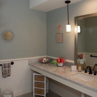 A well-organized bathroom with a modern vanity and ambient lighting.