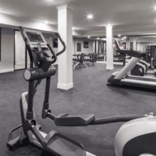 A modern gym equipped with treadmills and ellipticals.