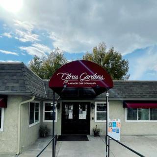 The entrance of a restaurant with a maroon awning and signage.