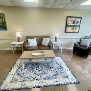 A cozy living room setup featuring a comfortable sofa, coffee table, and decorative elements.