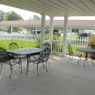 A welcoming outdoor patio space with metal tables and chairs, perfect for dining or relaxation.