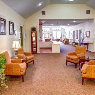 A cozy living room with comfortable seating and warm lighting.