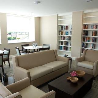 A modern library interior with comfortable seating and bookshelves.