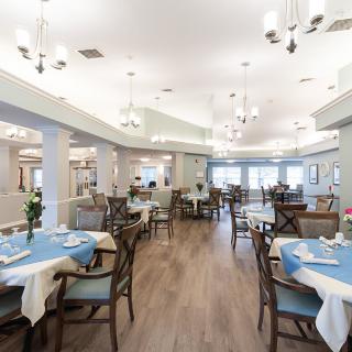 A spacious and elegantly designed restaurant dining area with neatly arranged tables and chairs.