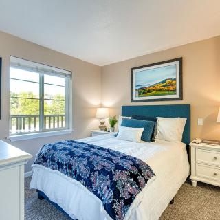 A cozy bedroom with a neatly made bed and soft lighting.