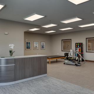 A modern reception area with fitness equipment and a welcoming atmosphere.