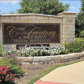 Entrance sign for The Conservatory at Wells Branch Senior Residences.