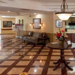 A well-lit hotel lobby with elegant flooring and comfortable seating.