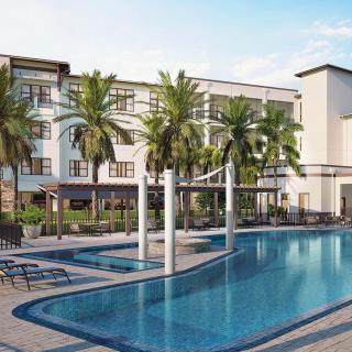 A serene resort featuring a swimming pool and palm trees.