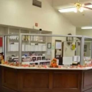 A reception desk area with office supplies and seasonal decorations.