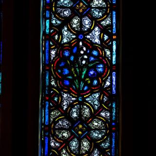 A beautifully intricate stained glass window with a colorful and decorative pattern.