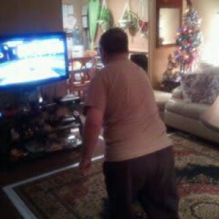 A person playing a video game in the living room.