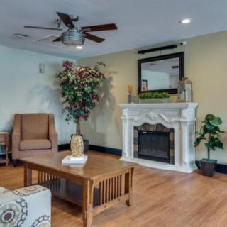 A cozy living room with a classic fireplace and comfortable seating.