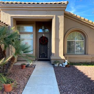 A welcoming entrance to a beautifully landscaped home.