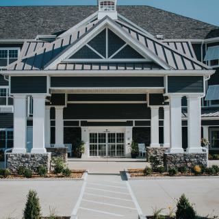 A modern residential building with a grand entrance.