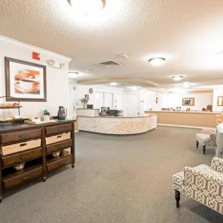 A well-lit reception lobby with modern furniture and a welcoming atmosphere.