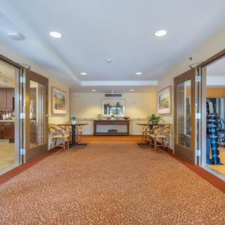 A welcoming hotel lobby with open doors, comfortable seating, and elegant decor.