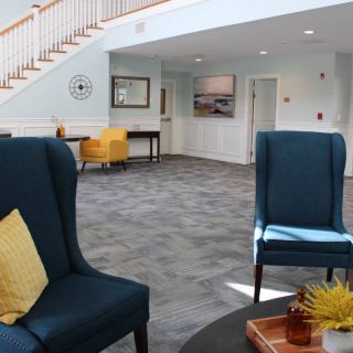 A modern lobby with stylish furniture and a staircase.