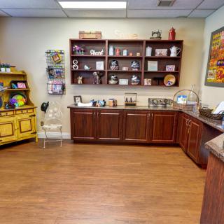 A cozy interior space featuring wooden cabinets and shelves displaying various decorative items.