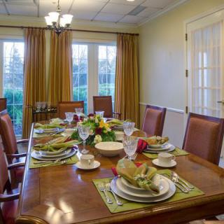 A well-set dining table in an elegantly decorated dining room.
