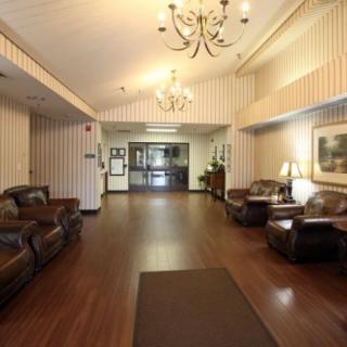 A spacious lobby with comfortable seating and a chandelier.