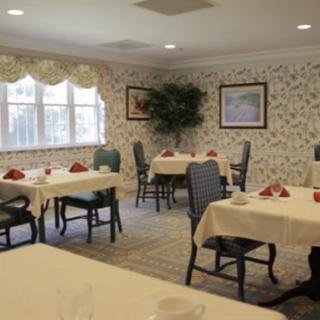 An elegantly decorated dining room with neatly set tables and chairs.