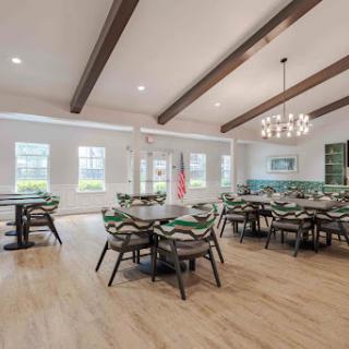 A modern dining area featuring elegant wooden beams and ample natural light, perfect for gatherings.