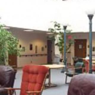 A cozy lobby area with comfortable seating and greenery.