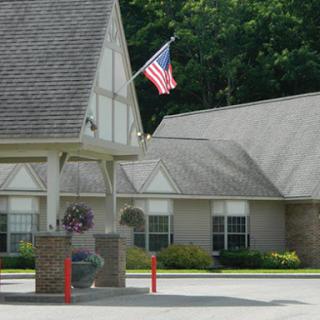 A charming residential building featuring an American flag in the foreground.