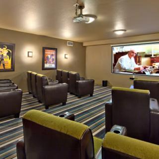 A cozy home theater setup featuring comfortable seating and a large screen.