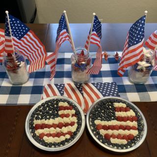 A festive table setup featuring American flag-themed desserts and decorations.